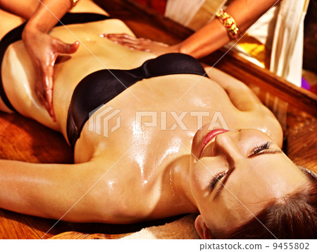 Woman having Ayurvedic spa treatment. 9455802