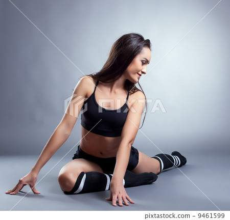 Image of pretty slim brunette doing stretching Image of pretty slim brunette doing stretching 9461599