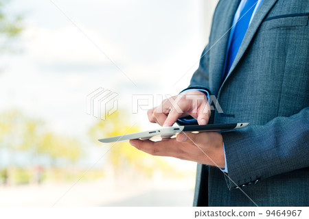 Businessman using tablet computer Businessman using tablet computer 9464967