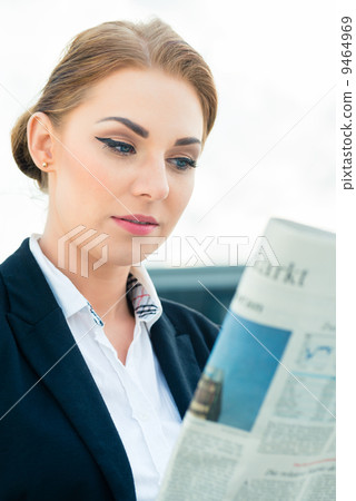 businesswoman reading business newspaper businesswoman reading business newspaper 9464969