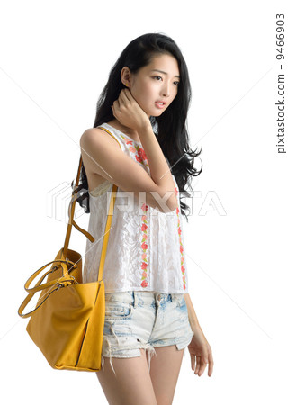 Teenage girl sleeveless top denim shorts casual wear studio in isolated white background Teenage girl sleeveless top denim shorts casual wear studio in isolated white background 9466903