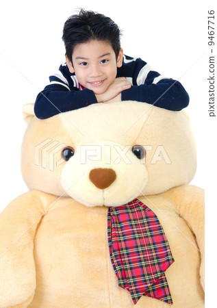 Asian boy with big bear doll . Asian boy with big bear doll . 9467716