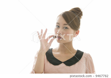 A young woman eating chocolate 9467782
