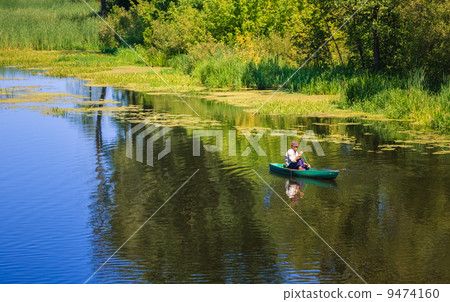 Man Fishing Out Of A Row Boat 9474160