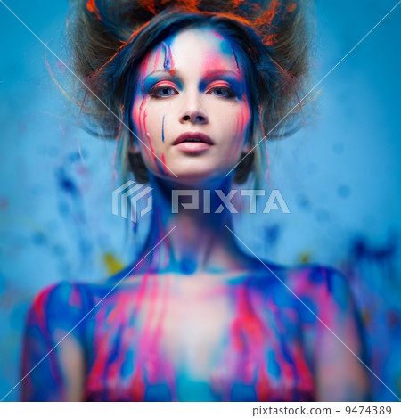 Young woman muse with creative body art and hairdo Young woman muse with creative body art and hairdo 9474389
