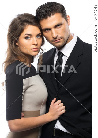 Beautiful young couple in suit and dress isolated on white background 9474545