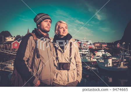 Young travellers couple in Reine village, Norway Young travellers couple in Reine village, Norway 9474665