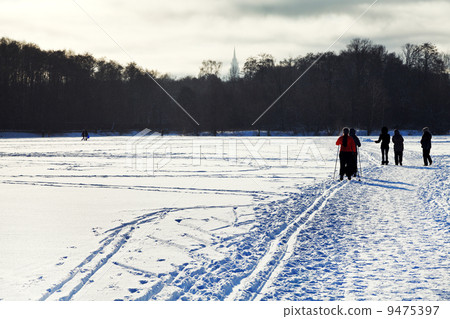 skiers and walking people on snowy field skiers and walking people on snowy field 9475397