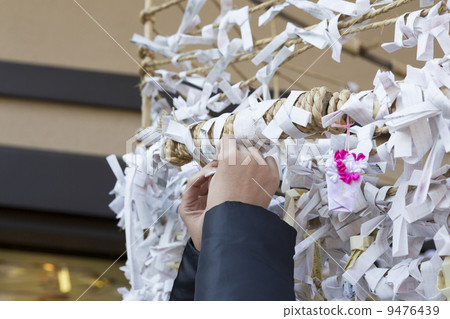 Hands tying a fortune 9476439