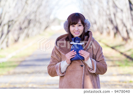 A woman giving a gift A woman giving a gift 9478040