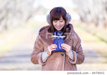 A woman giving a gift A woman giving a gift 9478041