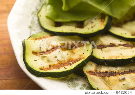 Grilled organic zucchini slices with herbs and spices Grilled organic zucchini slices with herbs and spices 9482034