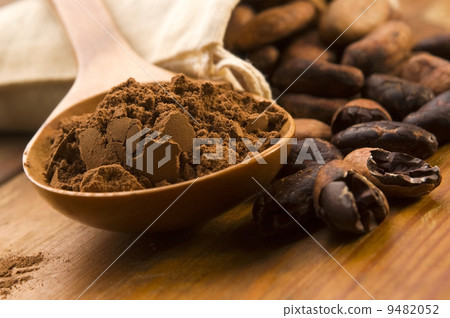 Cocoa (cacao) beans on natural wooden table 9482052