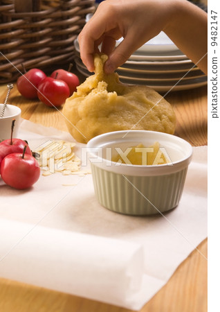 Detail of child hands making apple pie Detail of child hands making apple pie 9482147