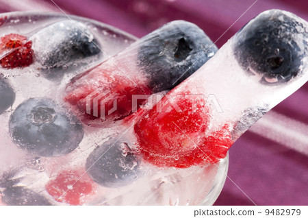 Raspberry and blackberry frozen in ice sticks 9482979