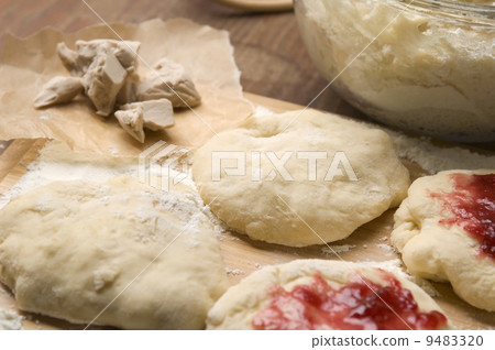 Dough with marmelade on wooden board Dough with marmelade on wooden board 9483320