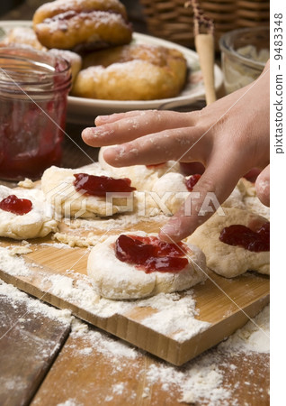 Detail of hands kneading dough 9483348