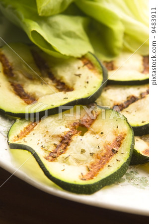 Grilled organic zucchini slices with herbs and spices Grilled organic zucchini slices with herbs and spices 9483911