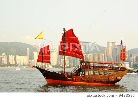 Hong Kong harbor with red sail boat 9488595