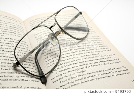 closeup of opened book and glasses. 9493793
