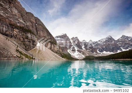 Calm water and mountain range Calm water and mountain range 9495102