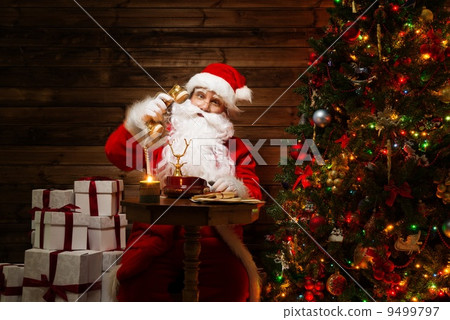 Santa Claus with phone in wooden home interior Santa Claus with phone in wooden home interior 9499797