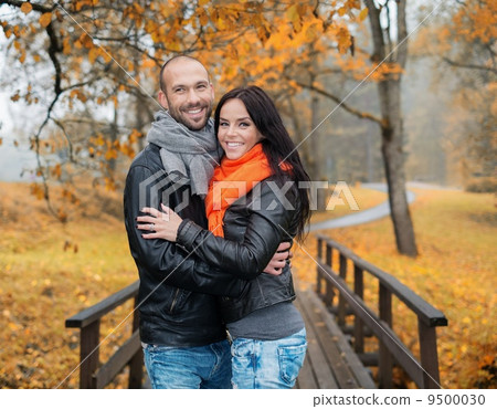 Happy middle-aged couple outdoors on beautiful autumn day 9500030