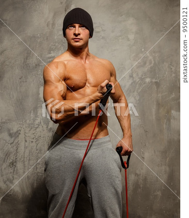 Handsome man with muscular body doing fitness exercise Handsome man with muscular body doing fitness exercise 9500121