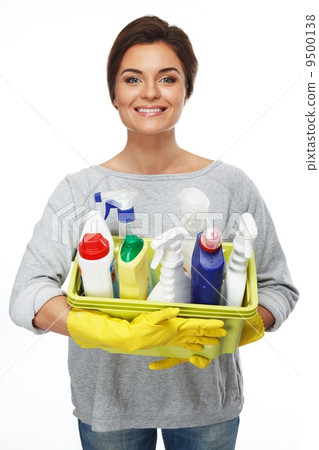 Beautiful cheerful brunette woman in gloves holding different cleaning stuff 9500138