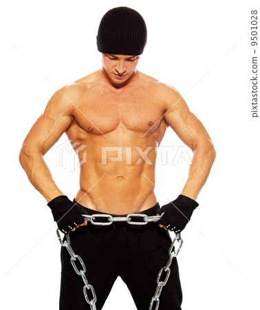 Handsome muscular man in beanie hat with chain 9501028