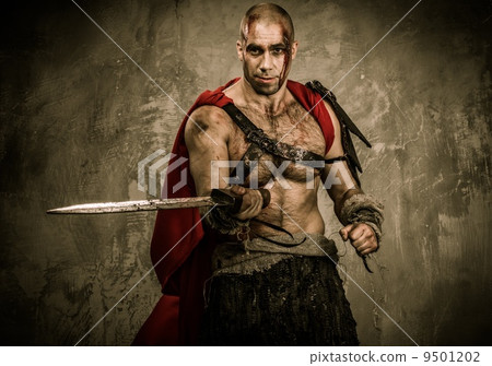 Wounded gladiator with sword covered in blood Wounded gladiator with sword covered in blood 9501202