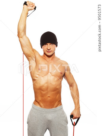 Handsome man with muscular body doing fitness exercise 9501573