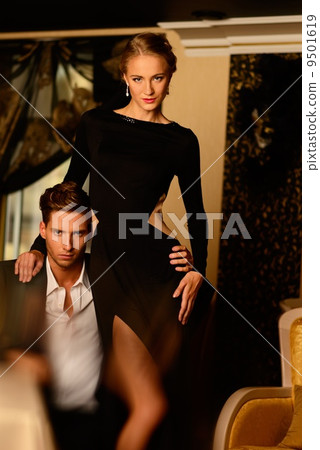 Sexy well-dressed young couple in luxury interior Sexy well-dressed young couple in luxury interior 9501619