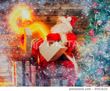 Santa Claus in wooden home interior holding gift box with magic star flying out of it Santa Claus in wooden home interior holding gift box with magic star flying out of it 9501620