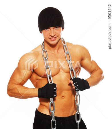 Handsome muscular man in beanie hat with chain 9501642