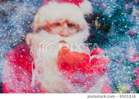 Santa Claus in wooden home interior blowing snow from his hands 9501816