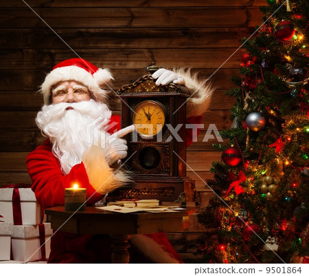 Santa Claus in wooden home interior showing time on a clock Santa Claus in wooden home interior showing time on a clock 9501864