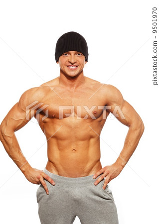 Handsome man with muscular torso in beanie hat posing Handsome man with muscular torso in beanie hat posing 9501970