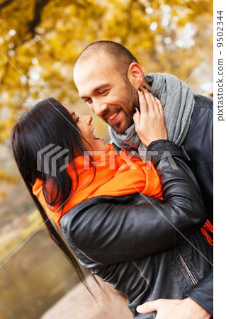 Happy middle-aged couple outdoors on beautiful autumn day 9502344