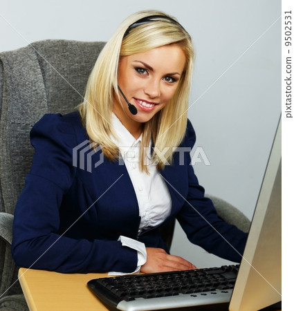 Beautiful blond help desk office support woman with headset Beautiful blond help desk office support woman with headset 9502531