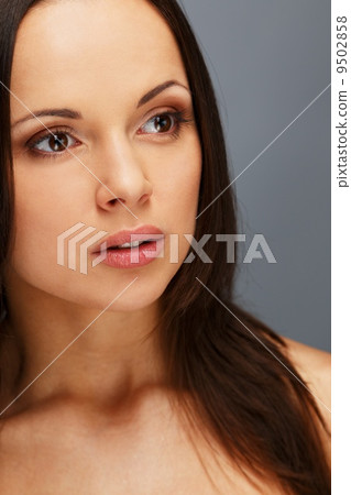 Beautiful young brunette woman with brown eyes and long hair 9502858