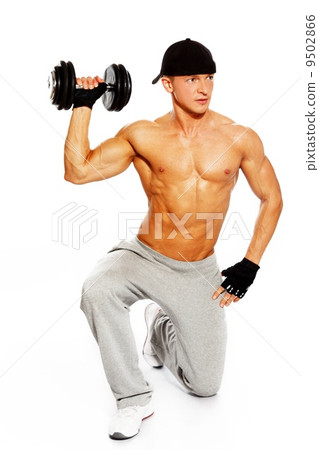 Handsome young muscular man exercising with dumbbells Handsome young muscular man exercising with dumbbells 9502866