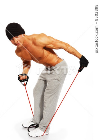 Handsome man with muscular body doing fitness exercise 9502899