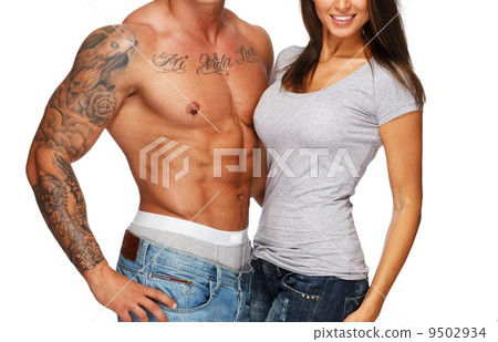 Young woman embracing man with naked muscular torso 9502934
