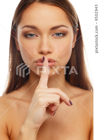 Beautiful young brunette woman showing to keep silence sign Beautiful young brunette woman showing to keep silence sign 9502943