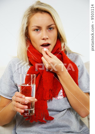 Sick young blond woman with pills and glass of water Sick young blond woman with pills and glass of water 9503114