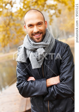 Positive middle-aged man alone on beautiful autumn day Positive middle-aged man alone on beautiful autumn day 9503121