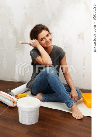 Happy beautiful young woman doing wall painting Happy beautiful young woman doing wall painting 9503156