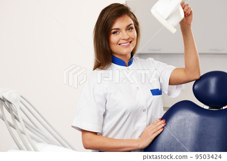 Young beautiful brunette woman dentist at dentist's surgery 9503424
