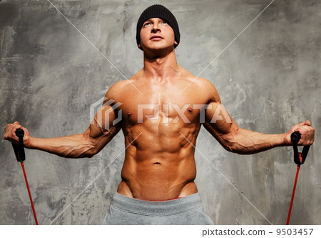 Handsome man with muscular body doing fitness exercise Handsome man with muscular body doing fitness exercise 9503457